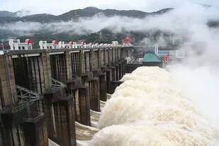 En esta imagen, distribuida por la agencia noticiosa china Xinhua, el agua sale de las compuertas de la estación hidroeléctrica de Shuikou, en la provincia suroriental de Fujian, en China, el 13 de junio de 2022. (Lin Shanchuan/Xinhua vía AP)