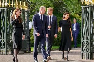 El príncipe Guillermo, y Kate, princesa de Gales, y el príncipe Harry y Meghan, duquesa de Sussex, salen de la puerta para ver los tributos florales para la difunta reina Isabel II fuera del Castillo de Windsor, en Windsor , Inglaterra, sábado 10 de septiembre de 2022. (AP Photo/Martin Meissner)