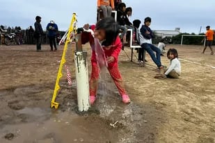 Una niña toma agua segura de un grifo, algo que hasta ese momento resultaba impensable en su comunidad.