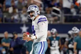 El quarterback de los Cowboys de Dallas, Dak Prescott, celebra tras un touchdown del running back Ezekiel Elliott en la primera mitad del juego contra los Eagles de Filadelfia, el lunes 27 de septiembre de 2021, en Arlington, Texas. (AP Foto/Ron Jenkins)