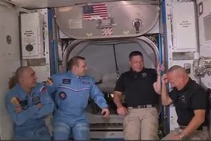 Doug Harley se toca la cabeza bajo la mirada atenta de su compañero Bob Behnken y los cosmonautas rusos de la Estación Espacial