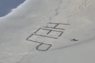 En un último esfuerzo para llamar la atención sobre su paradero, el surfer escribió "ayuda" en la arena