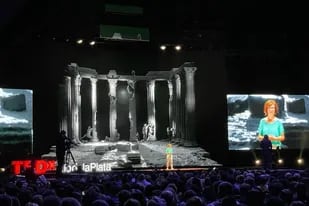Un pequeño astronauta recorre la parte superior de las columnas; es una obra de Lajos insertada en la puesta en escena para la charla TEDxRíodelaPlata 2022 de Yanina Welp; es un homenaje.