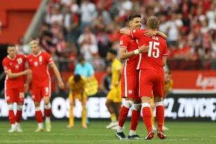Poland players celebrate at the end of the UEFA Nations League soccer match between Poland and Wales, at the Tarczynski Arena Wroclaw in Wroclaw, Poland, Wednesday, June 1, 2022. Poland defeated Wales 2-1. (AP Photo/Michal Dyjuk)