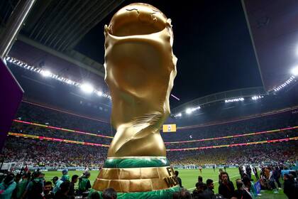 20 November 2022, Qatar, Al Khor: An Oversized replica of the World Cup trophy is in the arena during the opening ceremony of the FIFA World Cup Qatar 2022, prior to the Group A opening match between Qatar and Ecuador at Al Bayt Stadium. Photo: Tom Weller/dpa