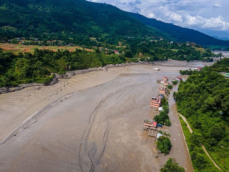 26 August 2026, Nepal, Nuwakot: An aerial view shows flooding along the Bhotekoshi River affecting low-lying areas and settlements near the riverbanks. Floodwaters reached residential areas and affected infrastructure along the river as emergency authorities continued to assess the extent of the damage and possible casualties. Photo: Ambir Tolang/JNA via ZUMA Press Wire/dpa