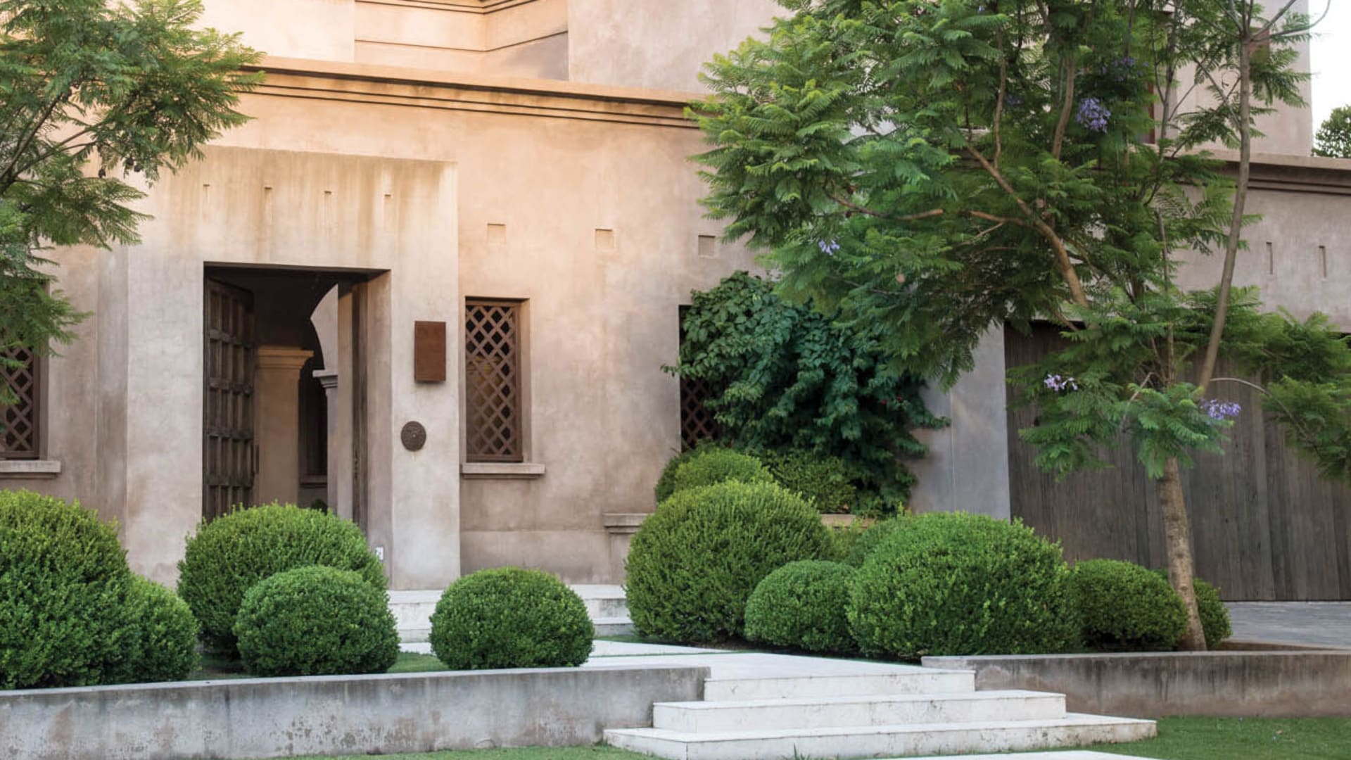 Un jardín de entrada con aires de palacio