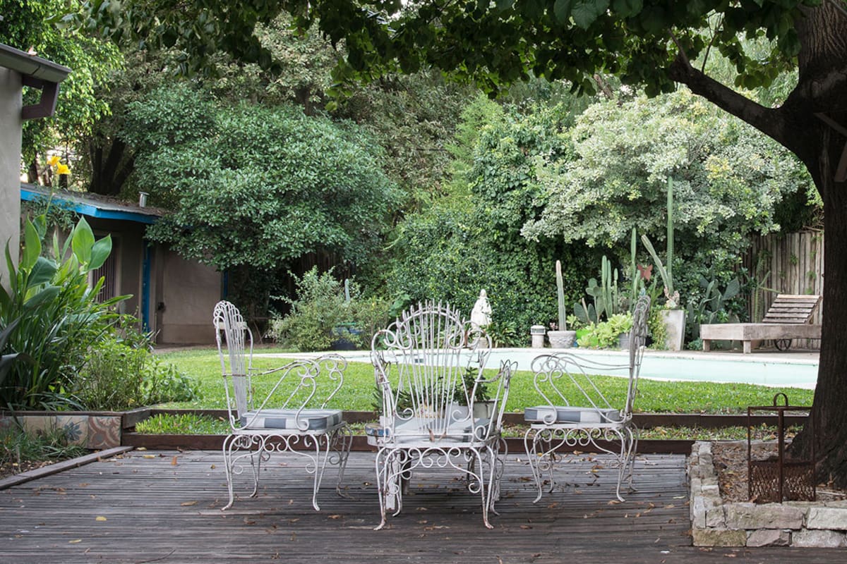 Con leves cambios de nivel como transición, la casa se transforma en patio bajo la sombra de un tilo con fuerte protagonismo y el patio en jardín.