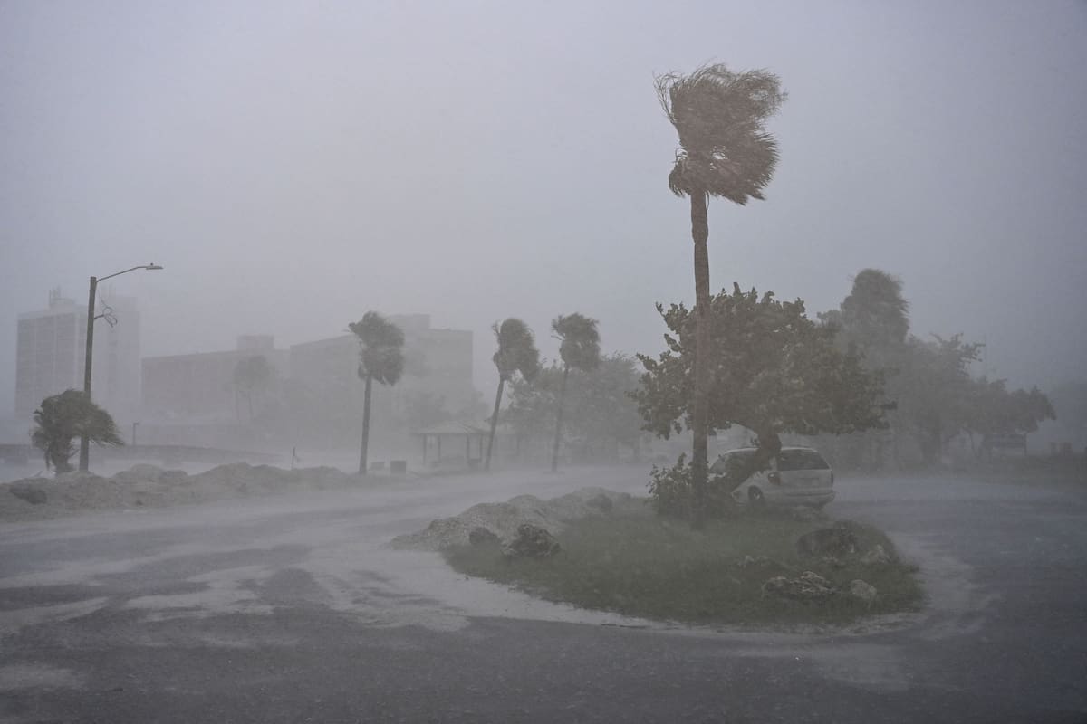 A car is seen parked as it rains heavily in Fort Myers, Florida, on October 9, 2024 as Hurricane Milton approaches. Milton regained power on October 8 to become a Category 5 storm with maximum sustained winds of 165 mph (270 kph) as it barrels towards the west-central coast of Florida and is forecast to make landfall late October 9, according to the National Hurricane Center