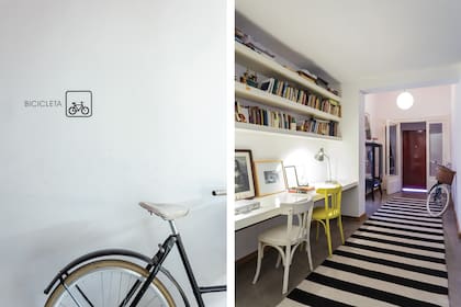 A continuación del hall, un área de paso donde se montó un gran escritorio con biblioteca y sillas de madera pintadas. La larga alfombra de lana rayada marca la circulación