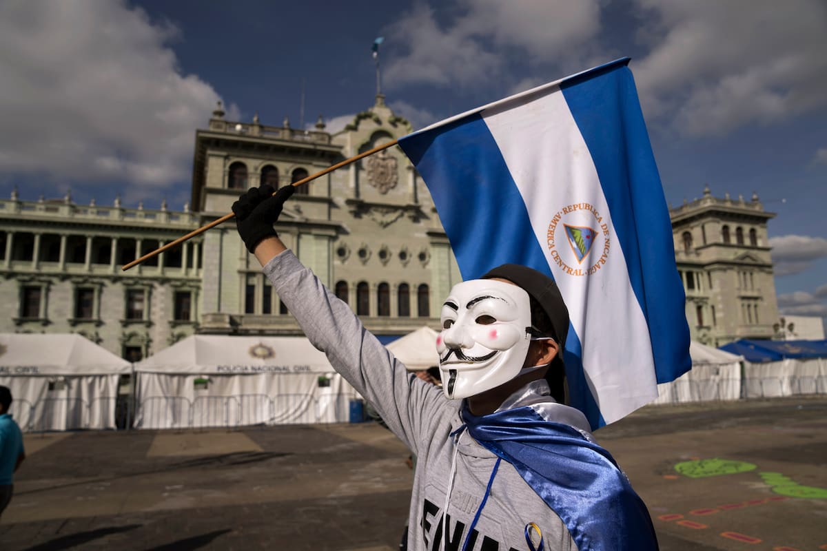 A Nicaraguan citizen protests against President Daniel Ortega at the Constitution Square in Guatemala City, Sunday, Nov. 7, 2021. Ortega seeks a fourth consecutive term against a field of little-known candidates while those who could have given him a real challenge sit in jail. (AP Photo/