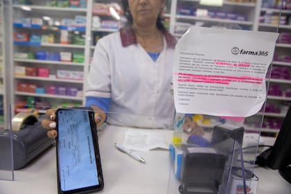 A partir del 1° de marzo de 20223, las farmacias dejan de recibir las recetas digitales, en la foto Belén empleada de una farmacia de Vicente Lopez atiende a Claudia y le recuerda la nueva disposición.