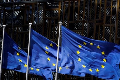 A picture taken on May 28, 2020 in Brussels shows the European Union flags fluttering in the aire outside the European Commission building in Brussels