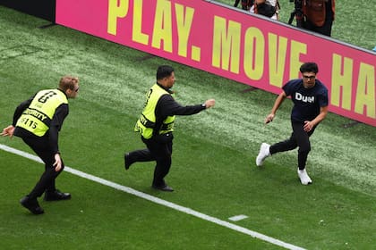 A pitch invader runs across the field during the World Cup round of 32 soccer match between Belgium and Senegal in Seattle, Wednesday, July 1, 2026. (AP Photo/Maddy Grassy)