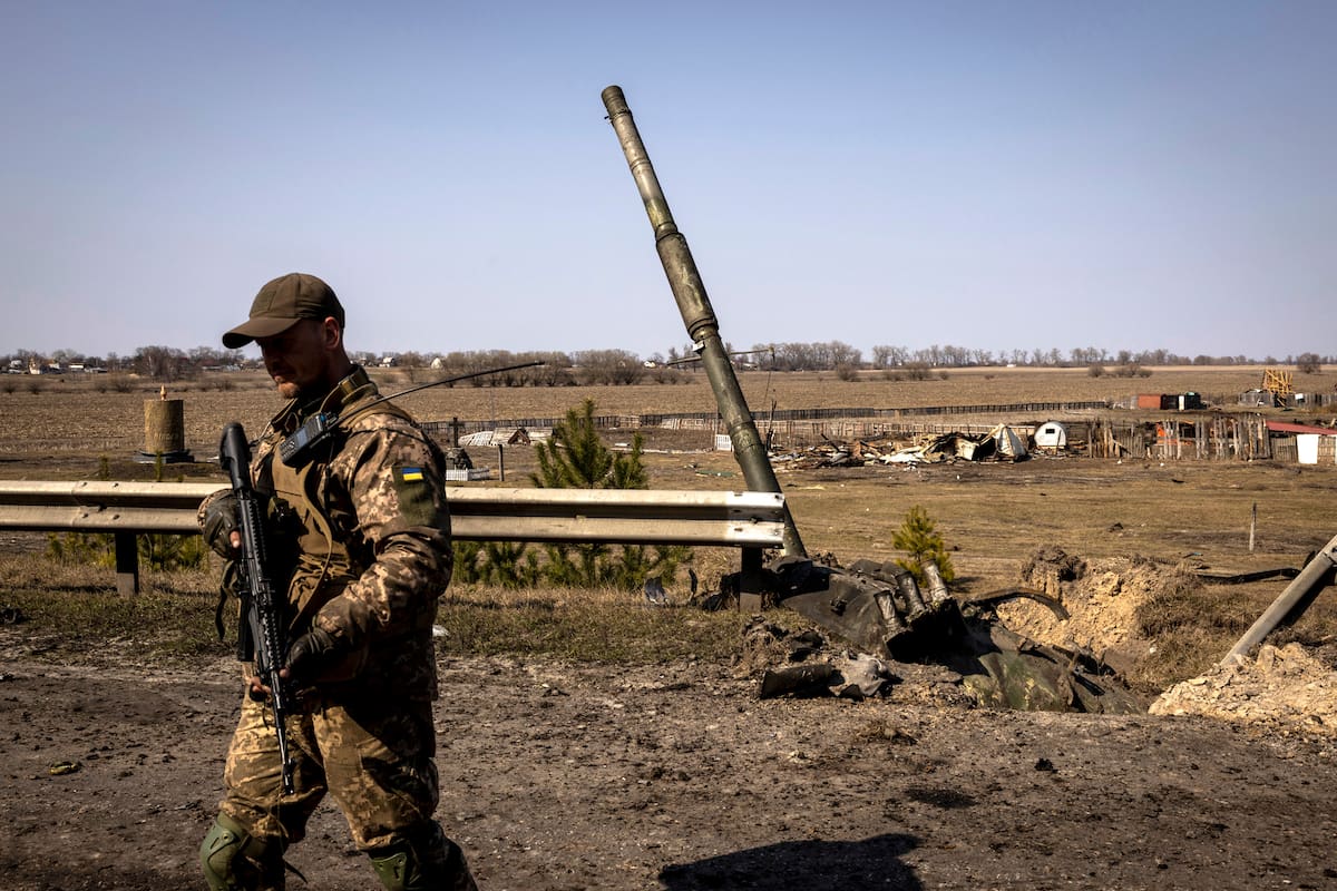 A Ukrainian soldier near a destroyed Russia tank at a frontline position in Kyiv, Ukraine, March 24, 2022. Destroyed tanks and body parts are all that are left of a Russian advance, part of the larger battle to block the invadersÕ attempt to enter or encircle the capital. (Ivor Prickett/The New York Times)