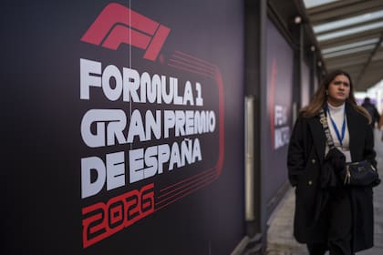 A woman walks past a banner announcing the next Formula One from 2026 at the IFEMA congress centre in Madrid, Spain, Tuesday, Jan. 23, 2024. A Madrid grand prix will join the Formula One calendar from 2026 on a track that will include street and non-street sections around the city's exhibition center. (AP Photo/Manu Fernandez)�