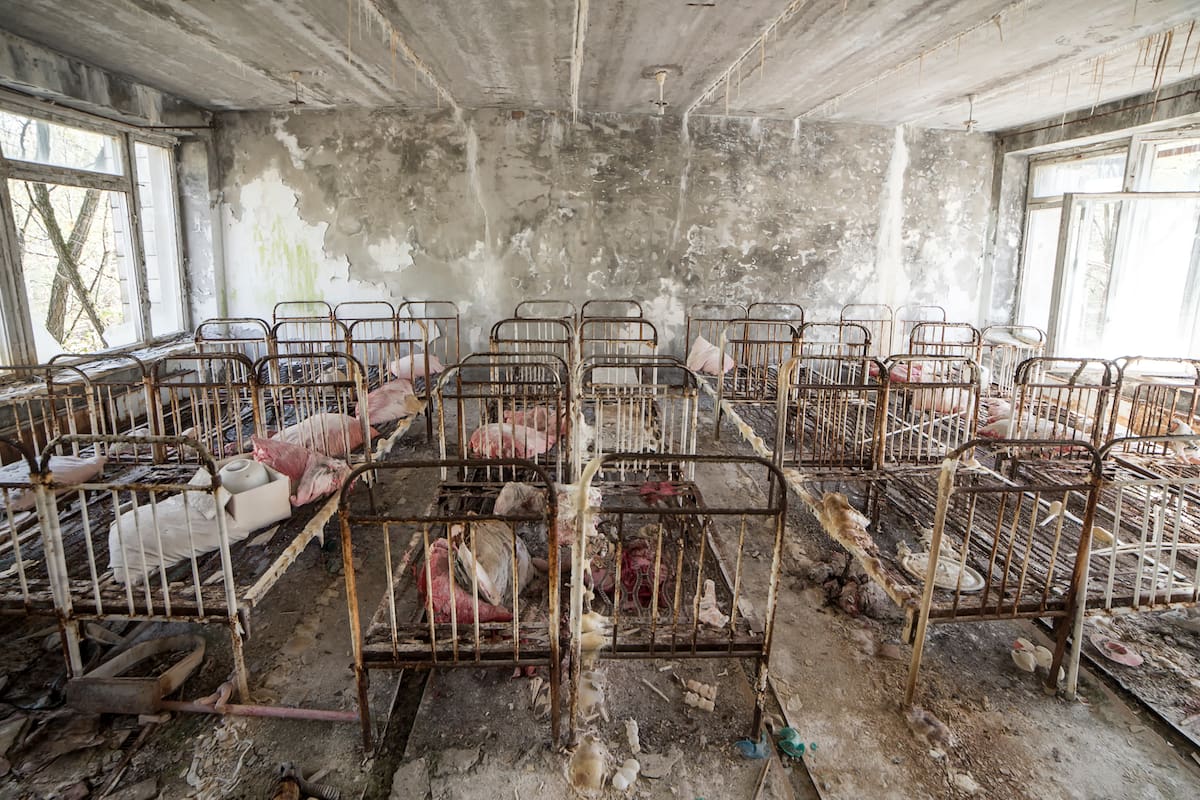Abandoned kindergarten in Chernobyl Exclusion Zone. Lost toys, A broken doll. Atmosphere of fear and loneliness. Ukraine, ghost town Pripyat.