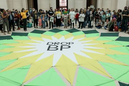 Activistas en Londres alrededor de un banner que dice "Drop BP", (no a BP) en el estilo del logo de la empresa en el Museo Británico
