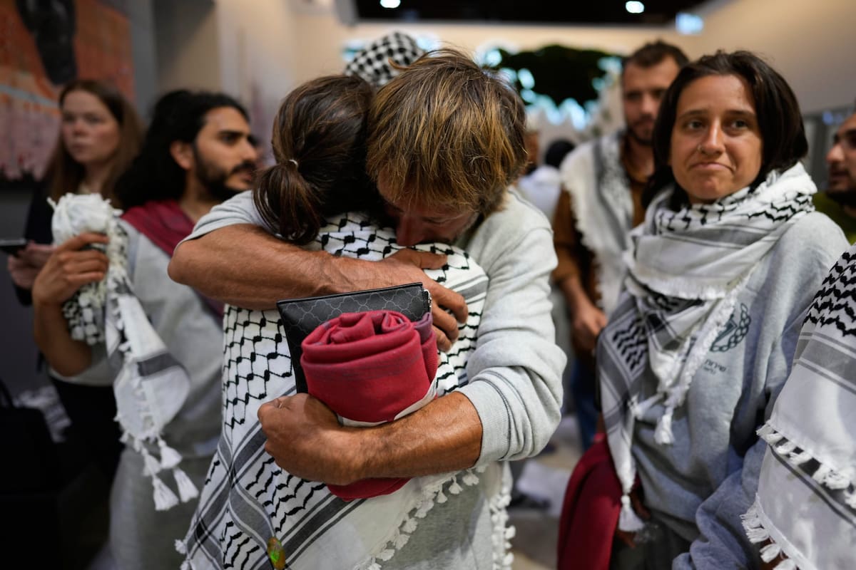 Activists from the Global Sumud Flotilla comfort each other upon their arrival at Istanbul Airport, in Istanbul, Turkey, Thursday, May 21, 2026. (AP Photo/Emrah Gurel)