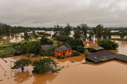 Aerial view shows a flooded area of Capela de Santana, Rio Grande do Sul state, Brazil, on May 2, 2024.�. Brazilian President Luiz Inacio Lula da Silva on Thursday visited the country's south where floods and mudslides caused by torrential rains have killed 13 people, with the toll likely to rise. Authorities in Rio Grande do Sul have declared a state of emergency, as rescuers continue to search for some 21 people reported missing among the ruins of collapsed homes, bridges and roads. (Photo by CARLOS FABAL / AFP)