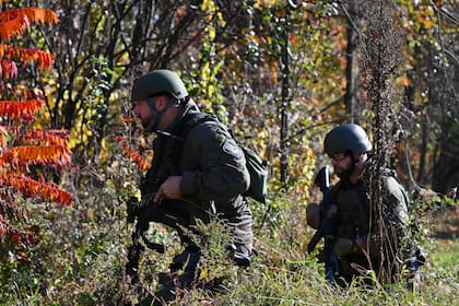 Agentes de las fuerzas de seguridad se acercan a una casa en Monmouth, Maine, el 27 de octubre de 2023, en busca de Robert Card