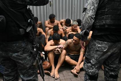 Agentes de policía junto a sospechosos arrestados durante la Operación Contención en la favela Vila Cruzeiro, en el complejo Penha, Río de Janeiro
