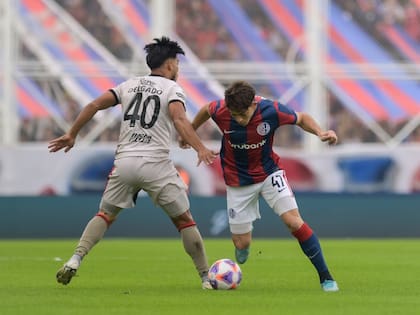 Agustín Giay, carrilero derecho de San Lorenzo, y Rafael Delgado, defensor central zurdo de Colón, disputan la pelota
