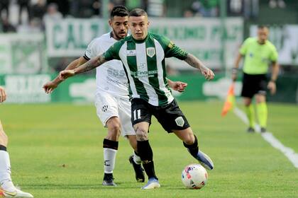 Agustín Urzi maniobra por el carril izquierdo; Banfield ganó su primer partido del campeonato