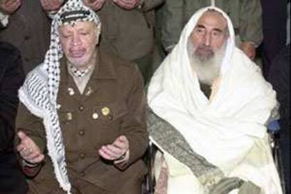 Ahmed Yassin reza junto a Yasser Arafat, en Gaza, en el año 2000