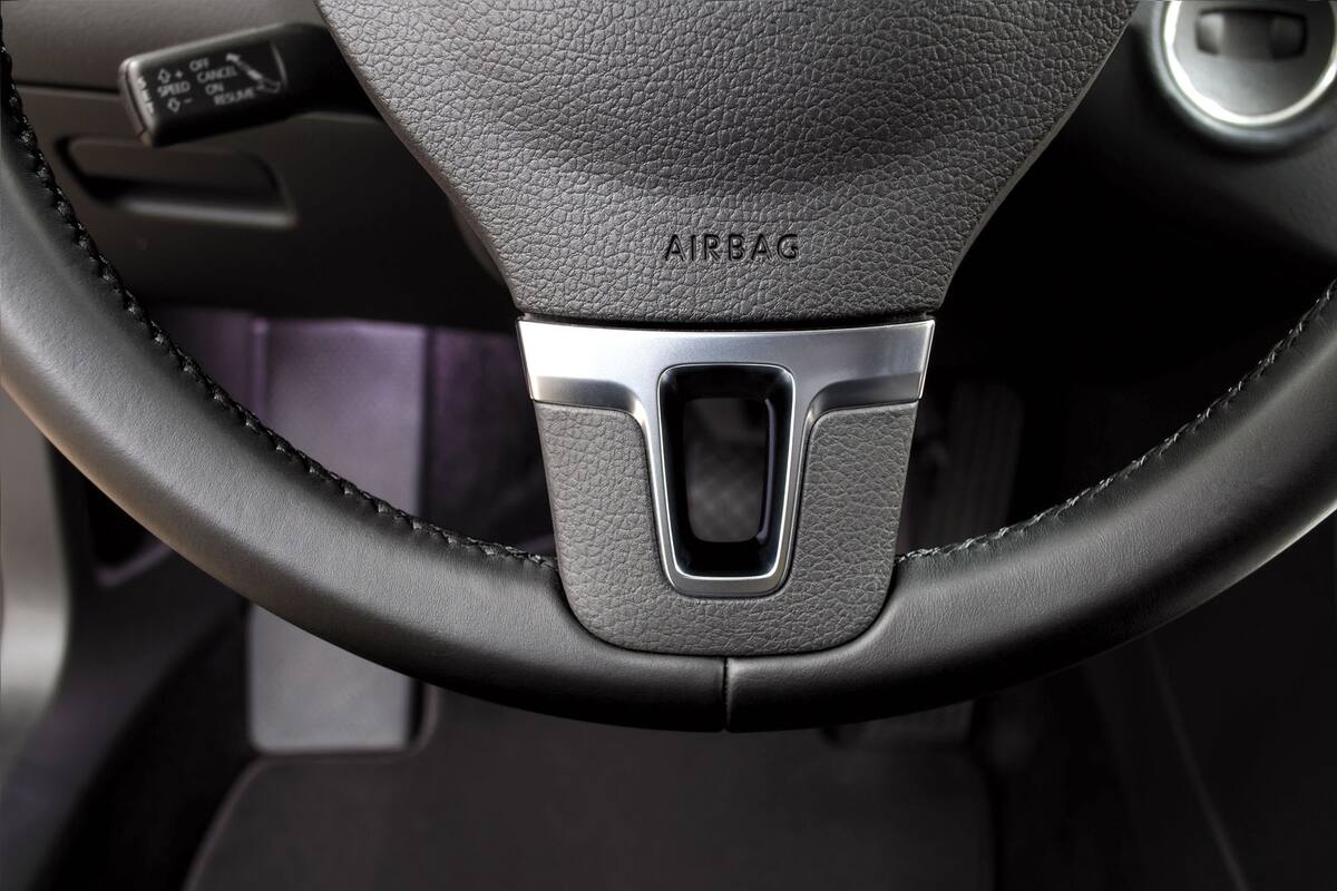 Airbag sign on steering wheel of car. Interior detail.
