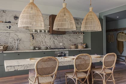 Alzada, mesada y tapa de la mesa de granito ‘Alpinus’ (Canteras del Mundo). Campana con acabado óxido (Compañía Nativa Estudio). Muebles de cocina en melamina ‘Safari’ (Faplac).