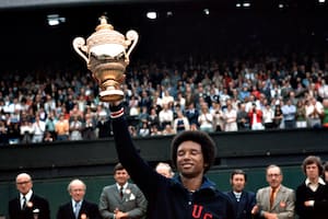 American tennis player Arthur Ashe (1943 - 1993) holds up his trophy after winning the men's singles of the Wimbledon Tennis Championship in London on July 5th, 1975. (Photo by UPI/Bettmann Archive/Getty Images)