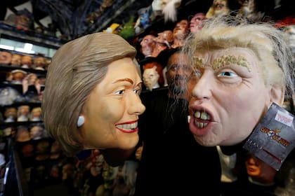 An employee holds up masks depicting Democratic presidential nominee Hillary Clinton and Republican presidential nominee Donald Trump at Hollywood Toys & Costumes in Los Angeles, California U.S.,