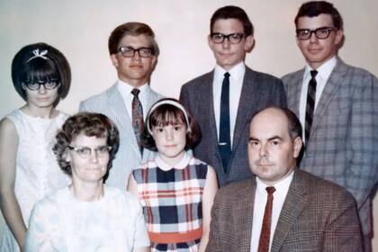 Andy Perkins (arriba, con traje blanco) se había sentido siempre distinto de su familia; décadas más tarde supo que había sido intercambiado con otro recién nacido en el hospital