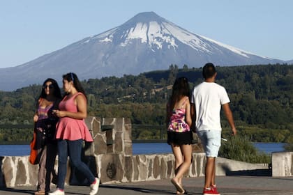 Apenas 500 personas quedan evacuadas por la erupción del Villarrica; en la imagen, dos parejas pasean por la orilla del lago homónimo, al sur de Chile