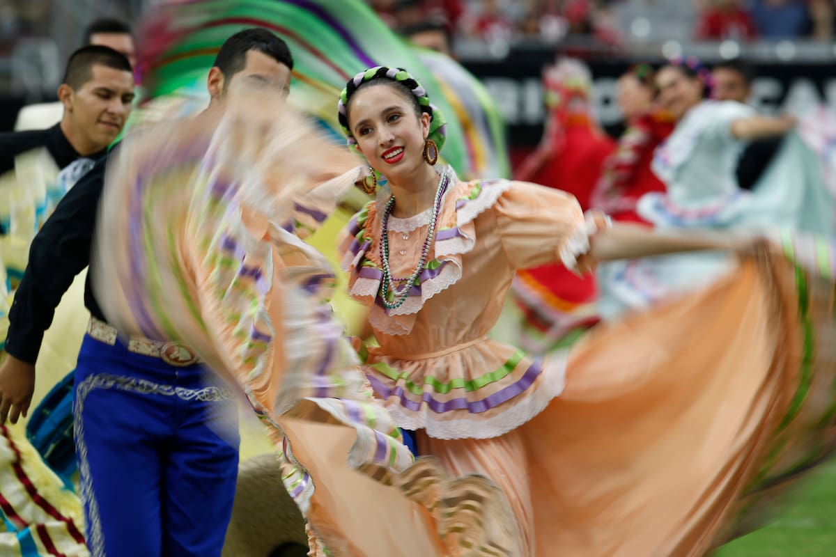 ARCHIVO - Integrantes del ballet folklórico bailan en las actividades del medio tiempo en honor al Mes de la Herencia Hispana durante un partido de la NFL entre los 49 ers de San Francisco y los Cardinals de Arizona, el 21 de septiembre de 2014, en Glendale, Arizona. (AP Foto/Ross D. Franklin, archivo)