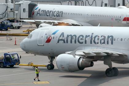 ARCHIVO - Jets de pasajeros de American Airlines preparan la partida desde una terminal del Aeropuerto Logan de Boston, 21 de julio de 2021. Un vuelo a Londres regresó a Miami porque una pasajera se negó a usar mascarilla, se informó el jueves 20 de enero de 2021. (AP Foto/Steven Senne, File)