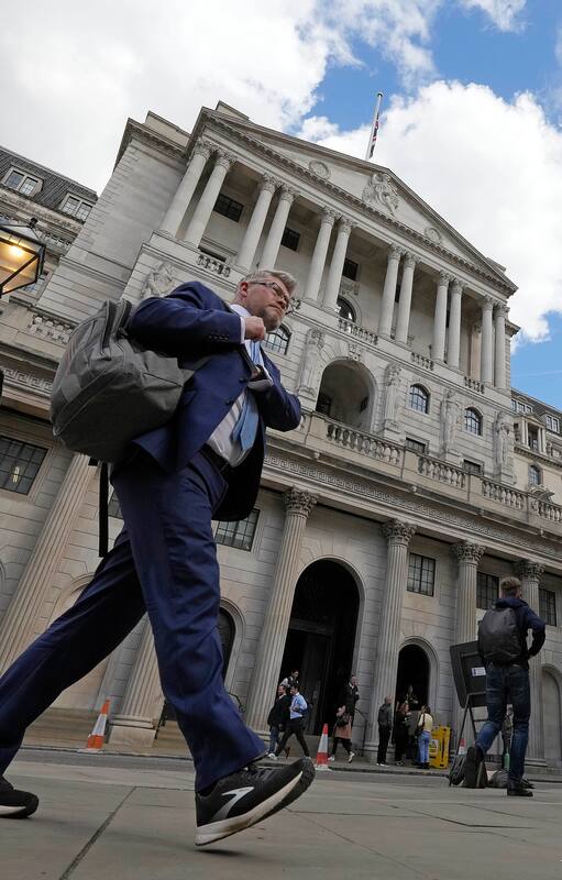ARCHIVO - Un hombre pasa frente al Banco de Inglaterra en el distrito financiero de Londres, 11 de mayo de 2023. (AP Foto/Frank Augstein)