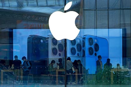 ARCHIVO - Unas personas compran en una tienda de Apple en Beijing, el martes 28 de septiembre de 2021. (AP Foto/Andy Wong, Archivo)