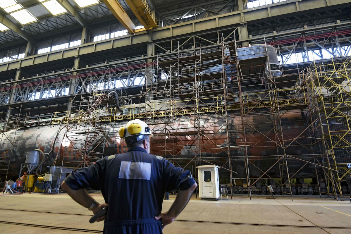 Argentina's Navy submarine ARA Santa Cruz, twin of missing submarine ARA San Juan, is pictured under repair at the state-operated Tandanor shipyard in Buenos Aires on December 26, 2017.
At a huge shed of the Tandador shipyard in the neighborhood of La Boca, dozens of workers go on with the reparations of submarine "ARA Santa Cruz", twin of "ARA San Juan", whose trace was lost on November 15 when it navigated he south Atlantic with its 44 crew members. / AFP PHOTO / EITAN ABRAMOVICH