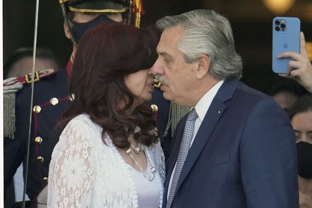 Argentina's President Alberto Fernandez (R) and Vice-President Cristina Fernandez de Kirchner approach to kiss each other after the inauguration of the 140th period of ordinary sessions in the Congress in Buenos Aires, on March 1, 2022. (Photo by NATACHA PISARENKO / POOL / AFP)