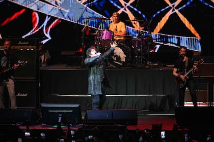 Argentina's President Javier Milei sings during his launch book La construcción del milagro at Movistar Arena in Buenos Aires on October 6, 2025 (Photo by Luis Robayo/AFP)