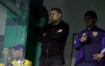Argentine former footballer and current vice-president of Boca Juniors Juan Roman Riquelme (C), and former Boca Juniors' players Hugo Ibarra (R) and Blas Giunta (L), watch players leave the field at the end of the Argentine Professional Football League match between Boca Juniors and Banfied at the Florencio Sola stadium in Banfield, Buenos Aires province, Argentina, on July 24, 2021.