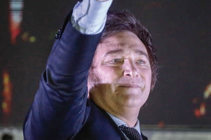 Argentine presidential candidate for the La Libertad Avanza alliance Javier Milei celebrates with supporters after winning the presidential election runoff outside his party headquarters in Buenos Aires on November 19, 2023. Libertarian outsider Javier Milei pulled off a massive upset Sunday with a resounding win in Argentina's presidential election, a stinging rebuke of the traditional parties that have overseen decades of economic decline. (Photo by Emiliano Lasalvia / AFP)