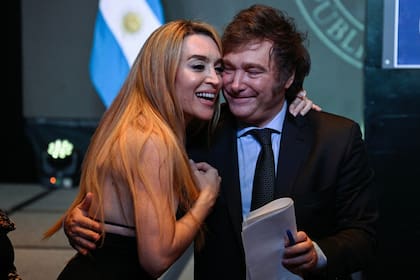 Argentine presidential candidate for the La Libertad Avanza alliance Javier Milei (R) celebrates with his girlfriend Fatima Florez after winning the presidential election runoff at his party headquarters in Buenos Aires on November 19, 2023. Libertarian outsider Javier Milei pulled off a massive upset Sunday with a resounding win in Argentina's presidential election, a stinging rebuke of the traditional parties that have overseen decades of economic decline. (Photo by LUIS ROBAYO / AFP)