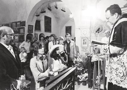 Arrodillados, los
novios escuchan con
atención las palabras del
sacerdote. Detrás, los
padrinos: el director de cine
Roger Vadim y la actriz
Nathalie Delon.