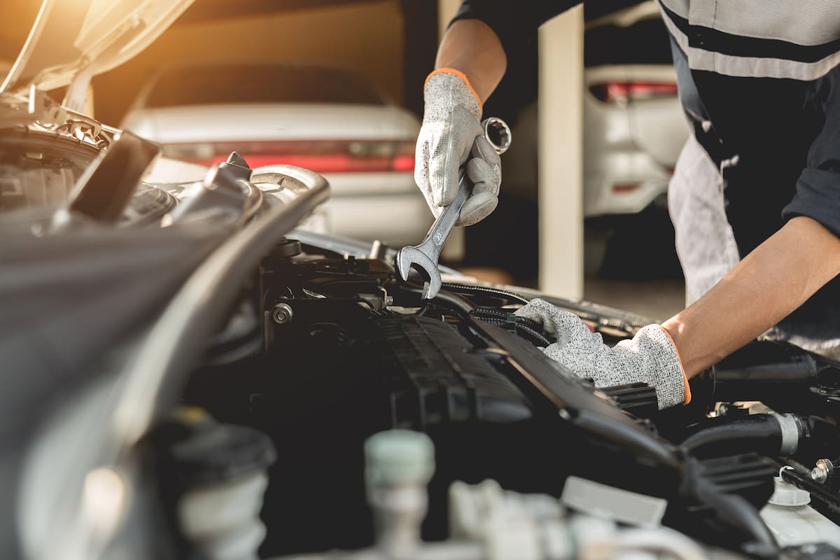 Automobile mechanic repairman hands repairing a car engine automotive workshop with a wrench, car service and maintenance,Repair service.