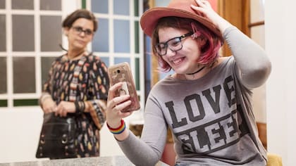 Avril interactúa con su celular ante la atenta mirada de su mamá, Lorena Artayeta