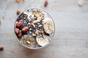 Banana chia yogurt pudding decorated with ripe sliced banana and peanuts