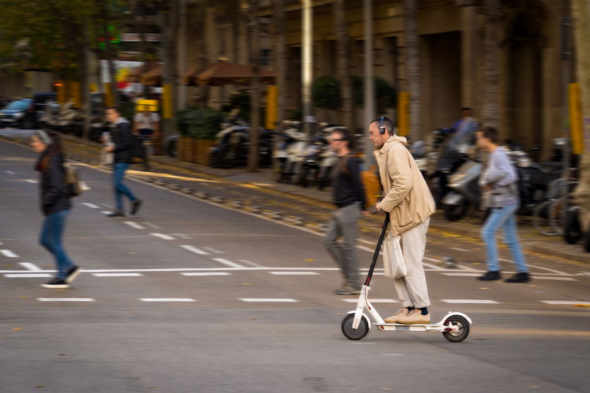 Barcelona, Spain. December 2018. Electric scooter riding in a street of Barcelona. EU cities like Barcelona have already prepared specific regulations since the use of these devices became a 'boom'